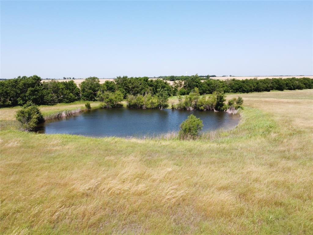 a view of a lake with houses in the back