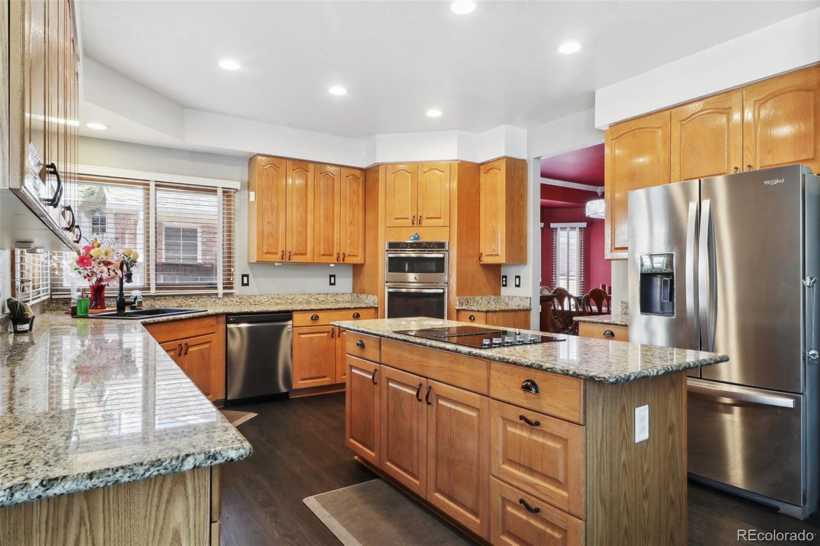 a kitchen with stainless steel appliances granite countertop refrigerator sink and cabinets