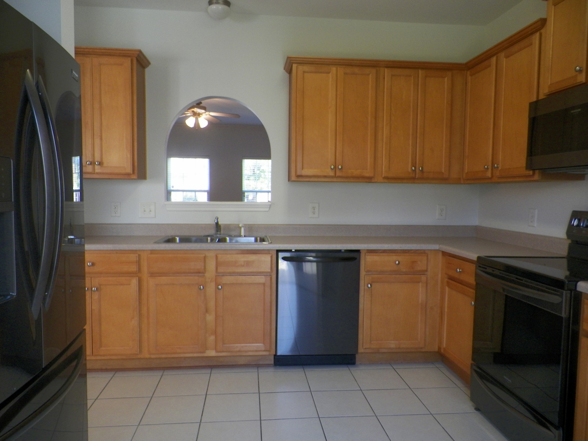 a kitchen with granite countertop a sink and a stove top oven