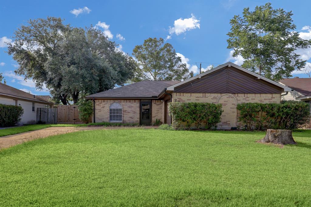 Welcome home! The front offers a spacious driveway for friends and family to park and a 2 car garage on the right