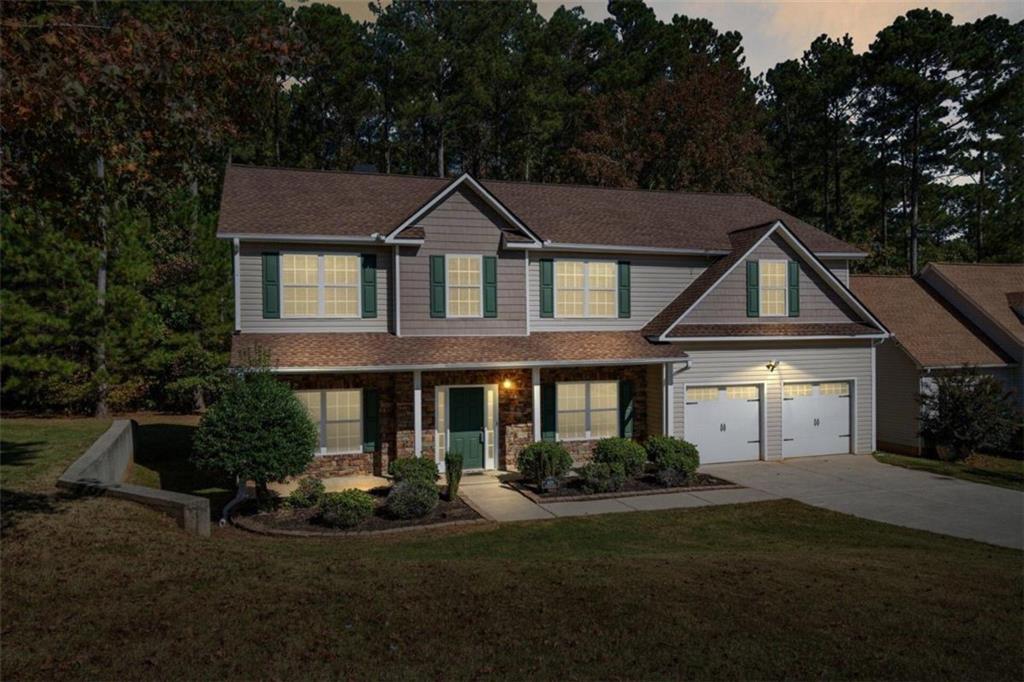 a front view of a house with a yard and garage