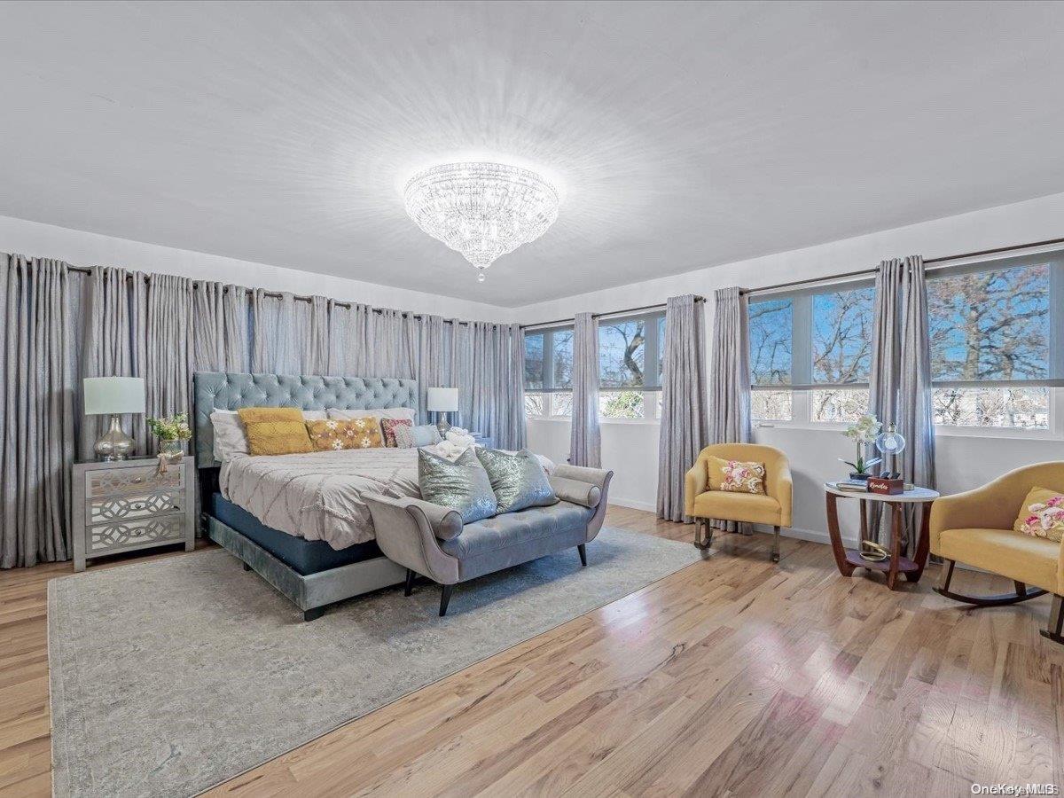 a bedroom with furniture and wooden floor