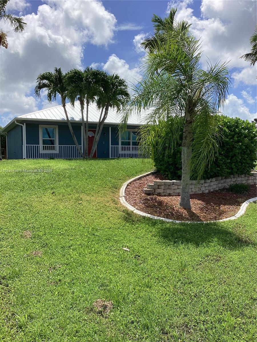 a view of a house with a backyard