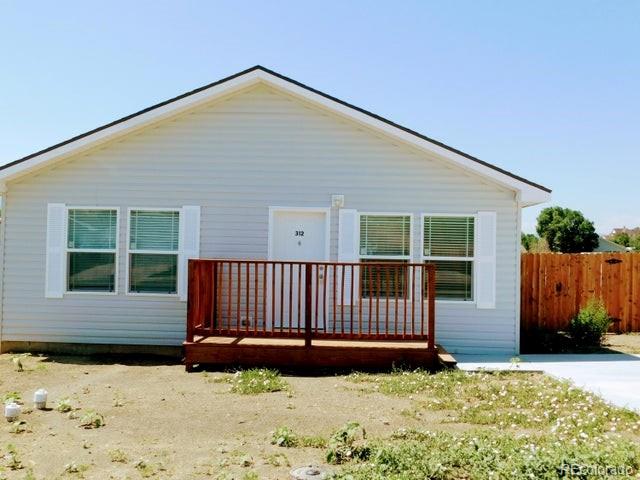 a view of a house with wooden fence