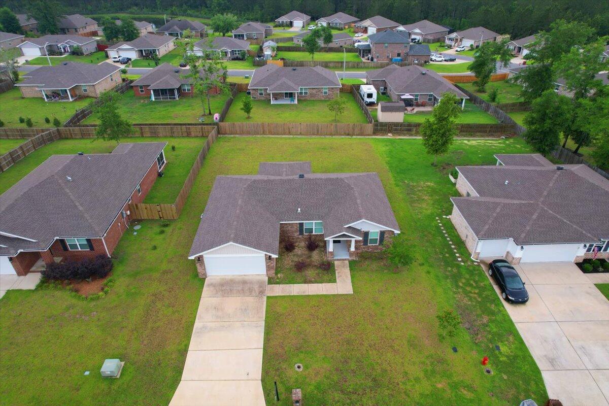 an aerial view of a house with a garden and lake view