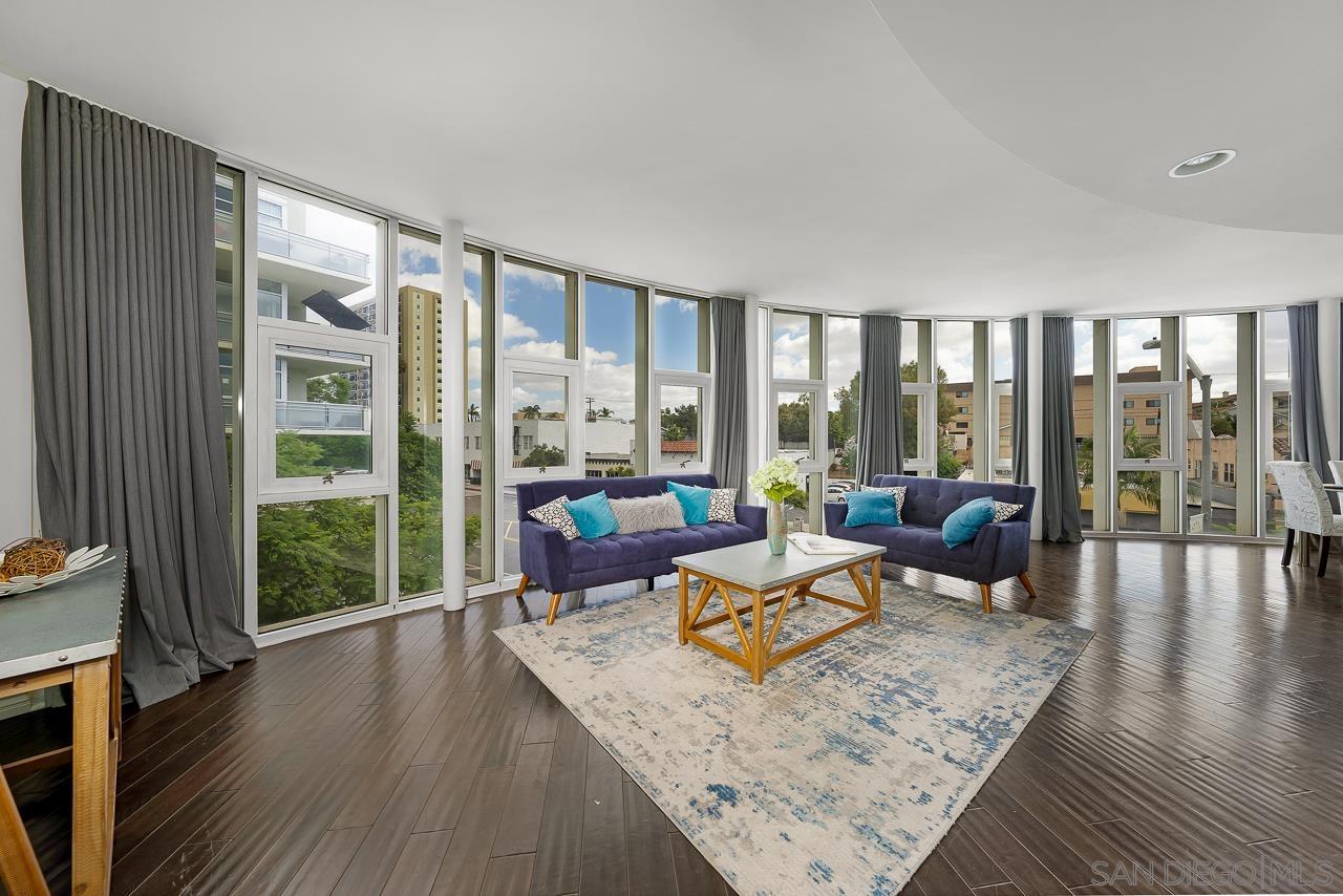 a living room with furniture and a floor to ceiling window