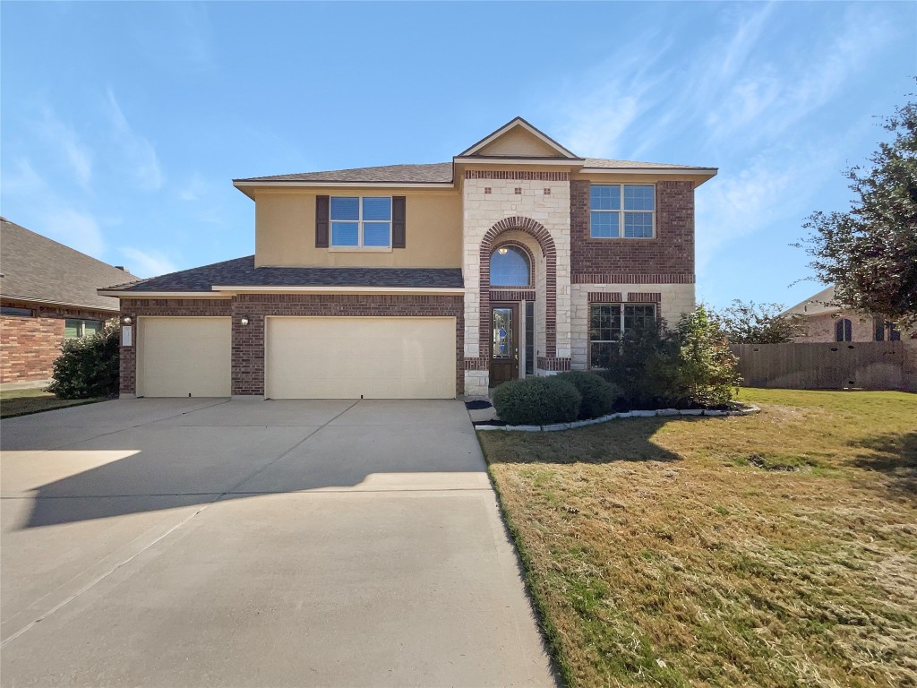 a front view of a house with a yard