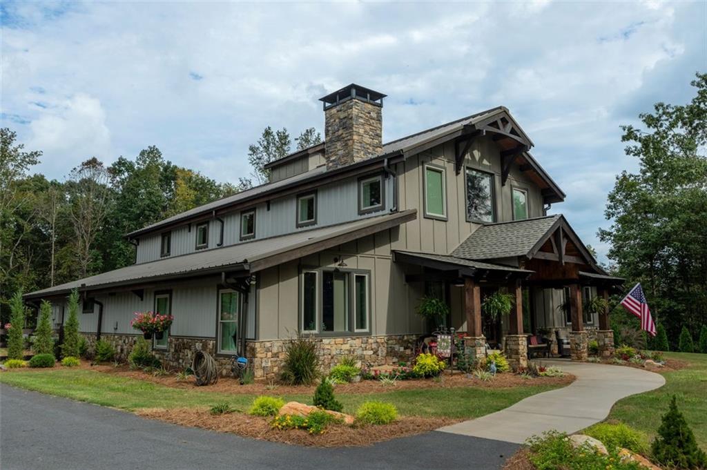 a front view of a house with yard outdoor seating and entertaining space