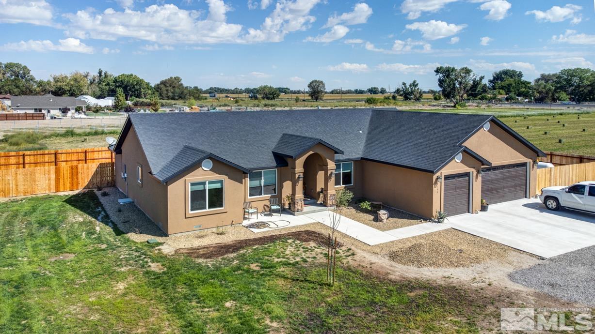 an aerial view of a house with yard and lake view