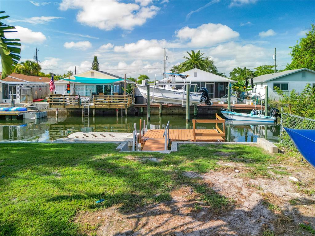 Back yard with floating dock and floating jet ski platform