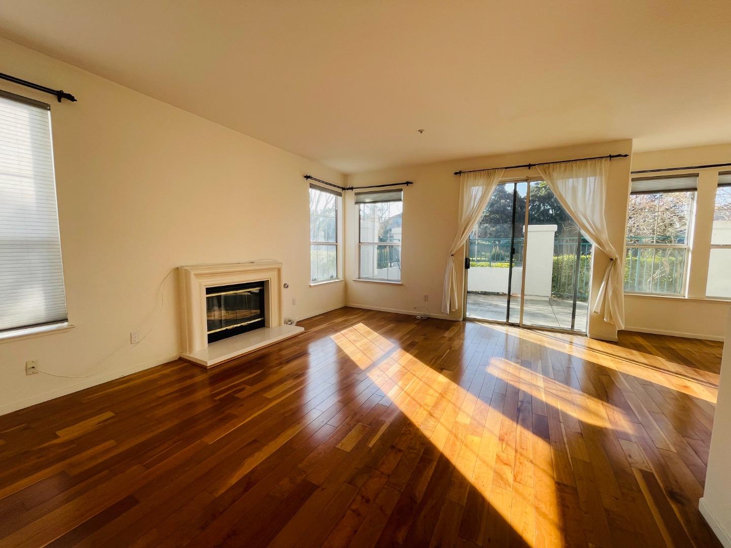 a spacious bedroom with a bed and wooden floor