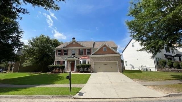 a front view of a house with a yard