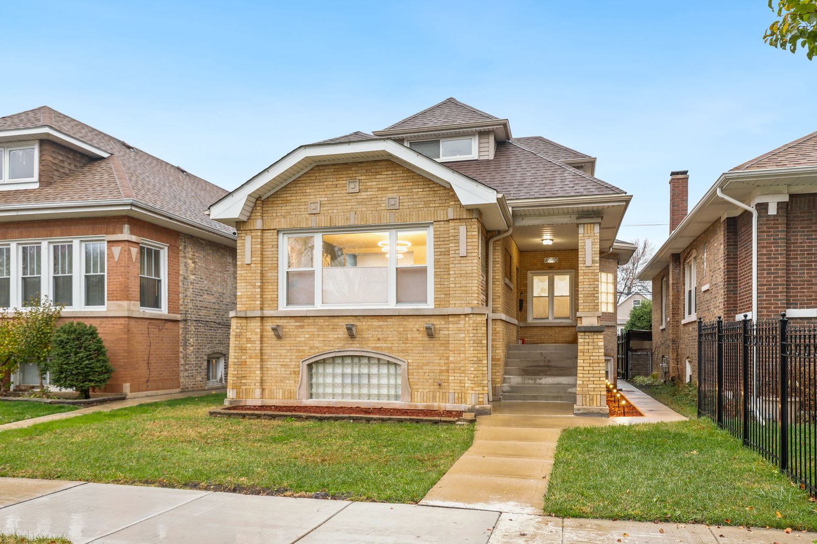 a view of a brick house with a yard