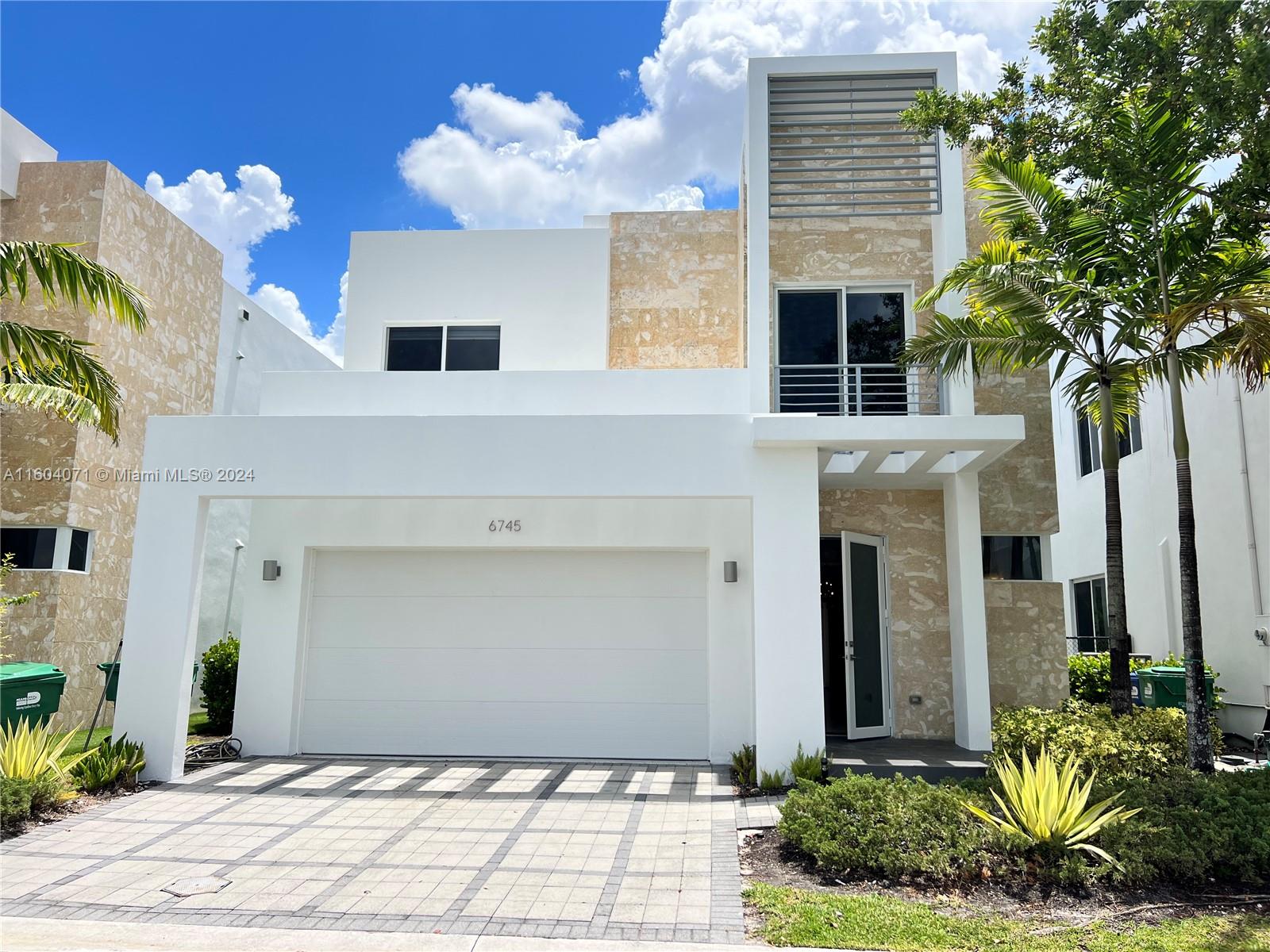 a front view of a house with a garage