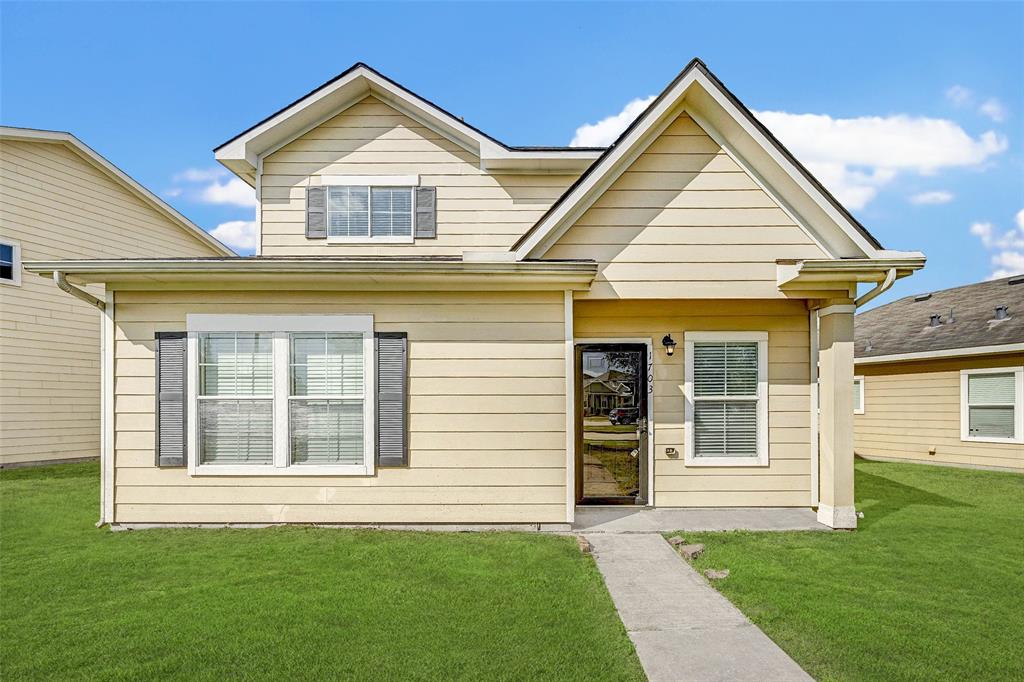 a view of a house with a yard