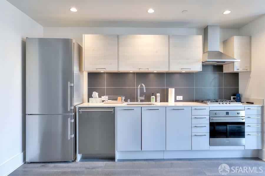 a kitchen with a stove a refrigerator and a sink