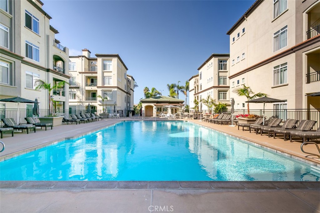 a swimming pool view with a outdoor seating space