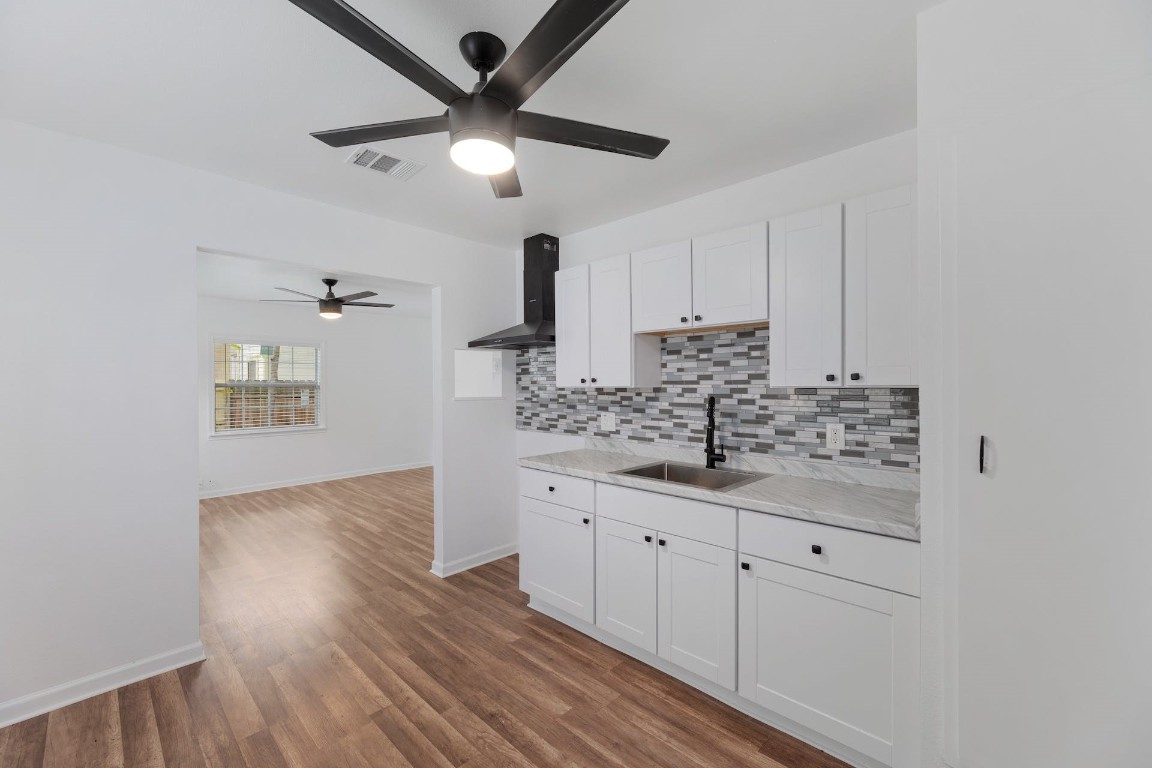 a kitchen with granite countertop a sink and cabinets