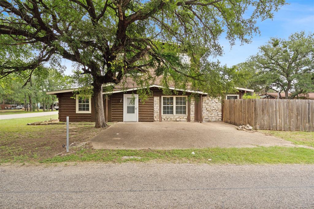 a house that has a tree in front of it