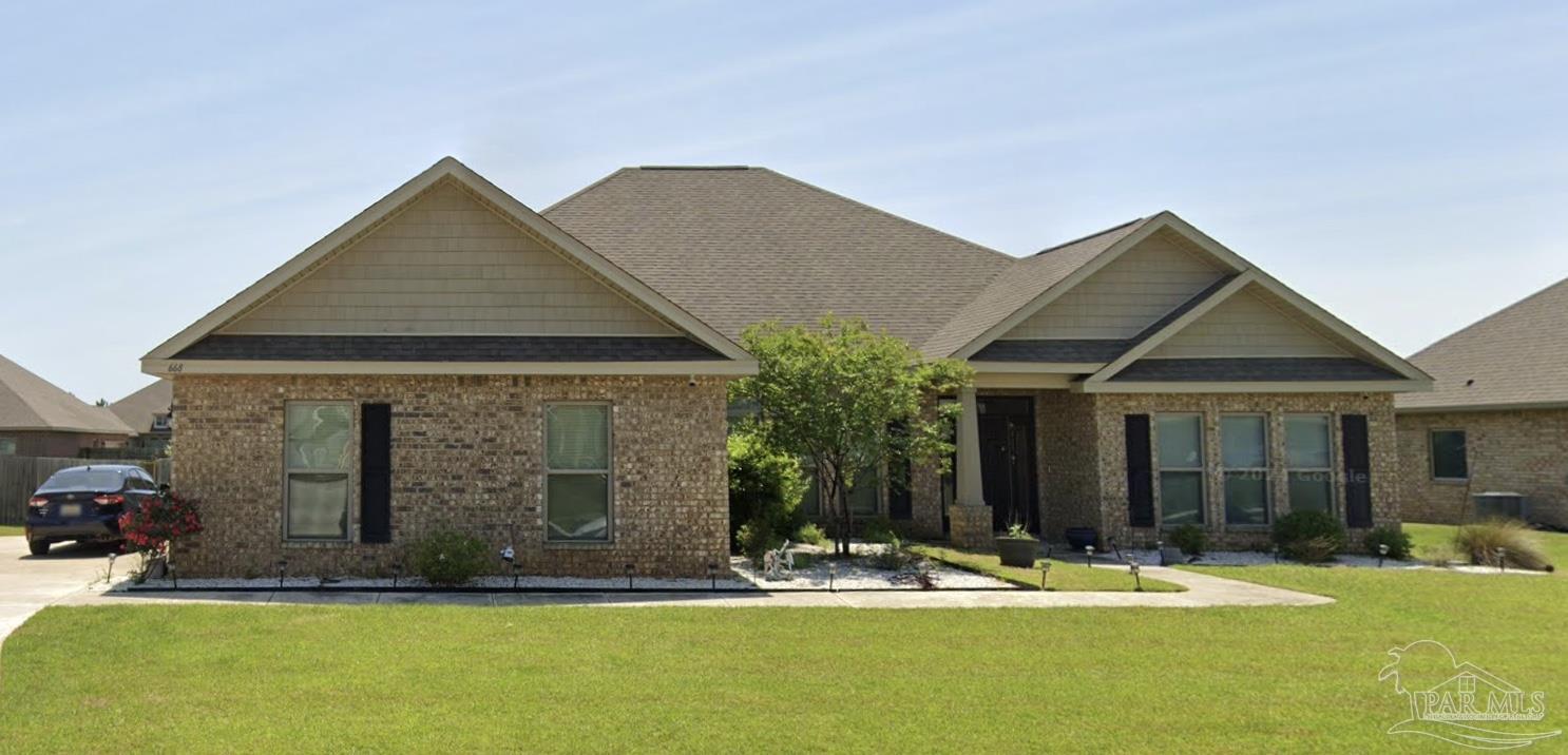 a front view of a house with garden