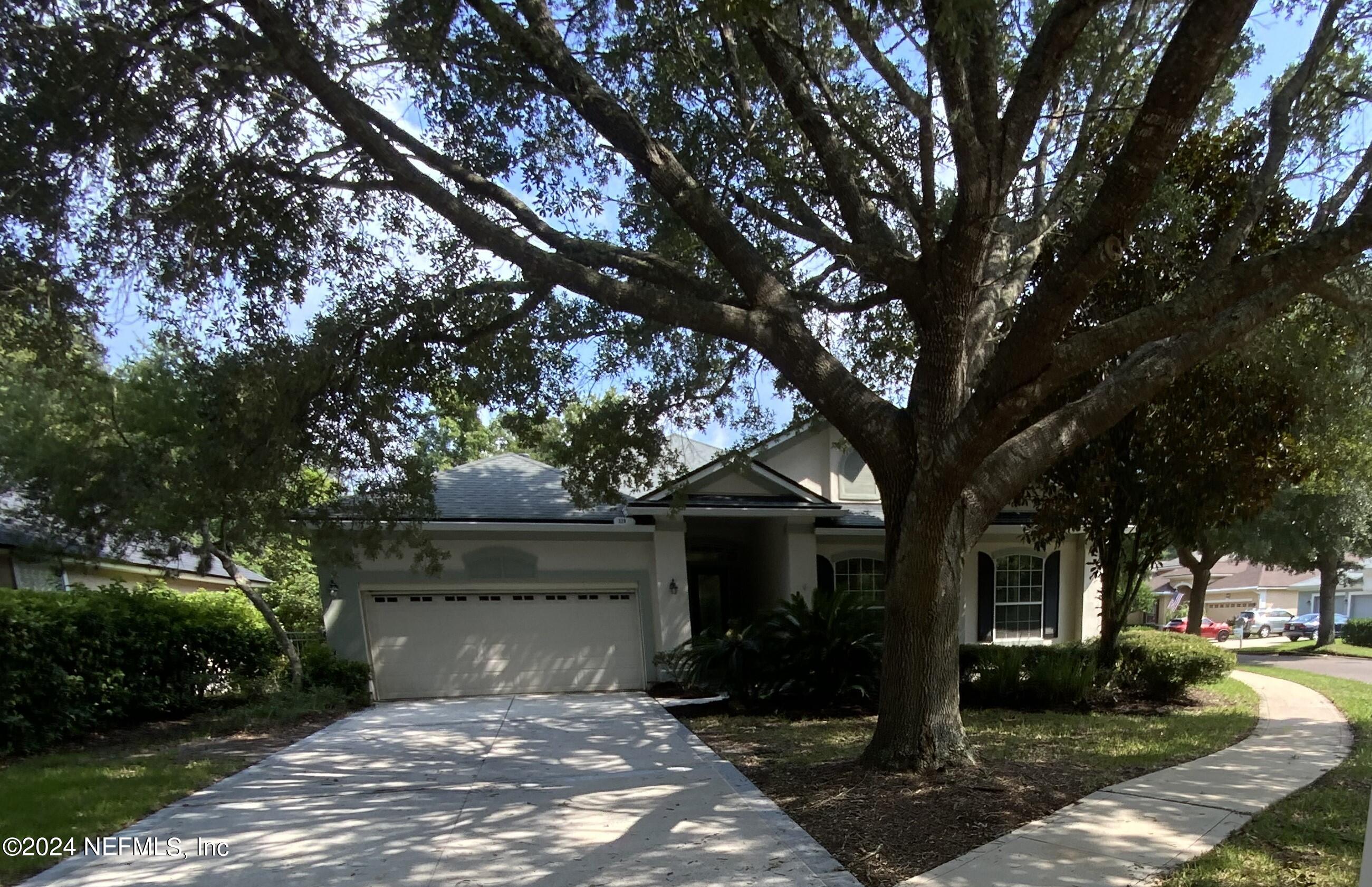 front view of a house with a tree