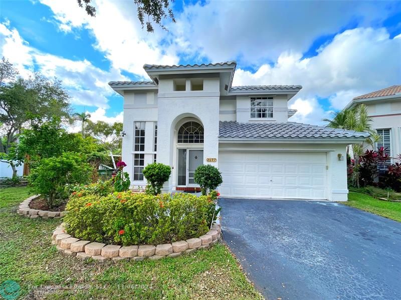 a front view of a house with a yard