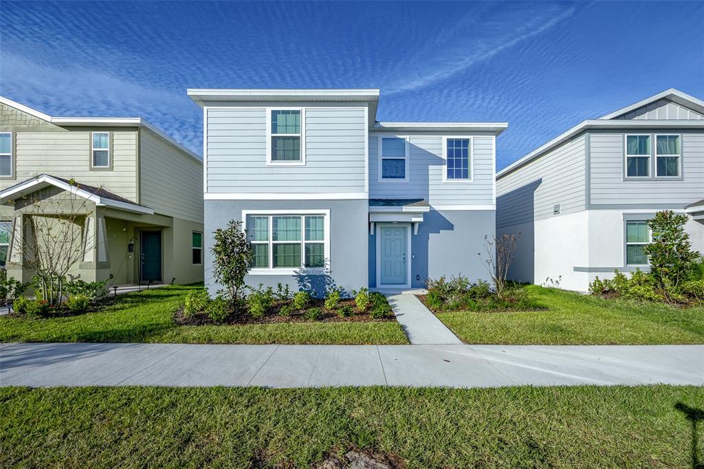 a front view of a house with a yard