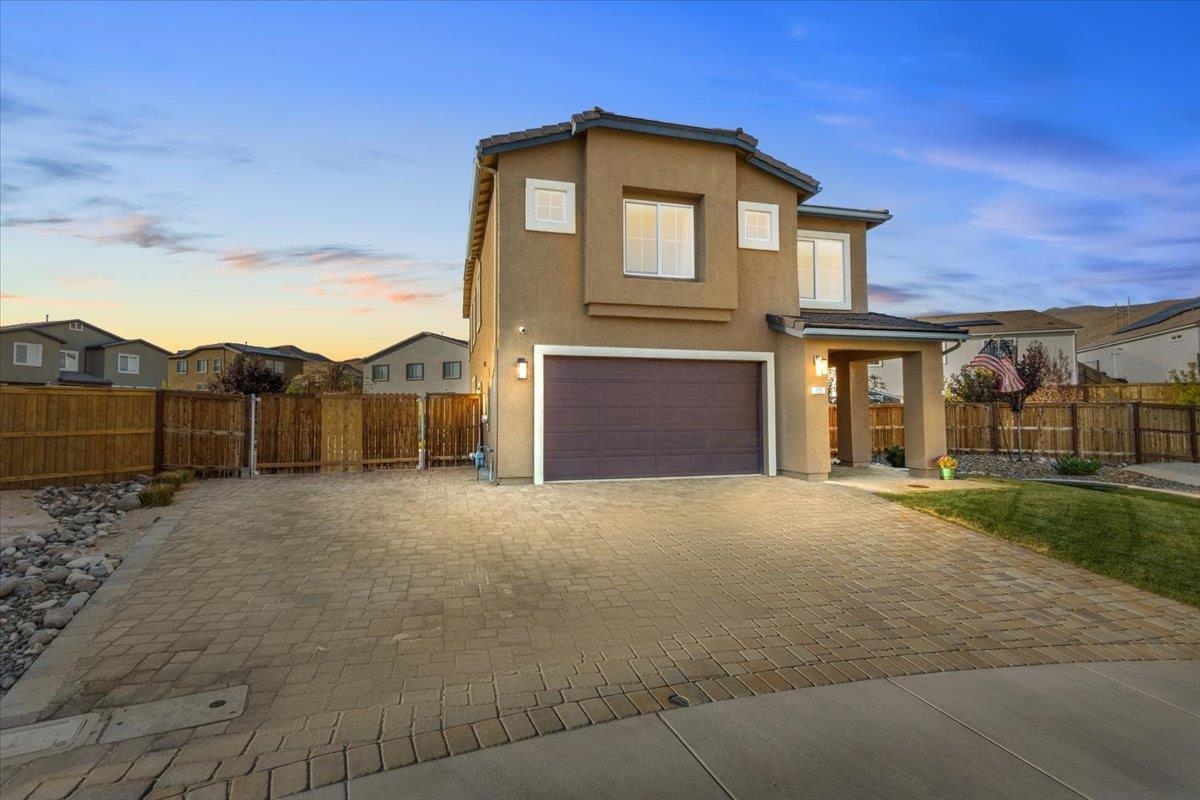 a front view of a house with a yard and garage