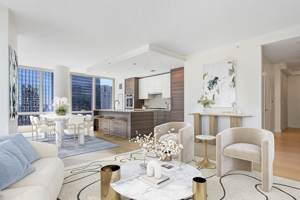 a living room with furniture and a dining table with kitchen view