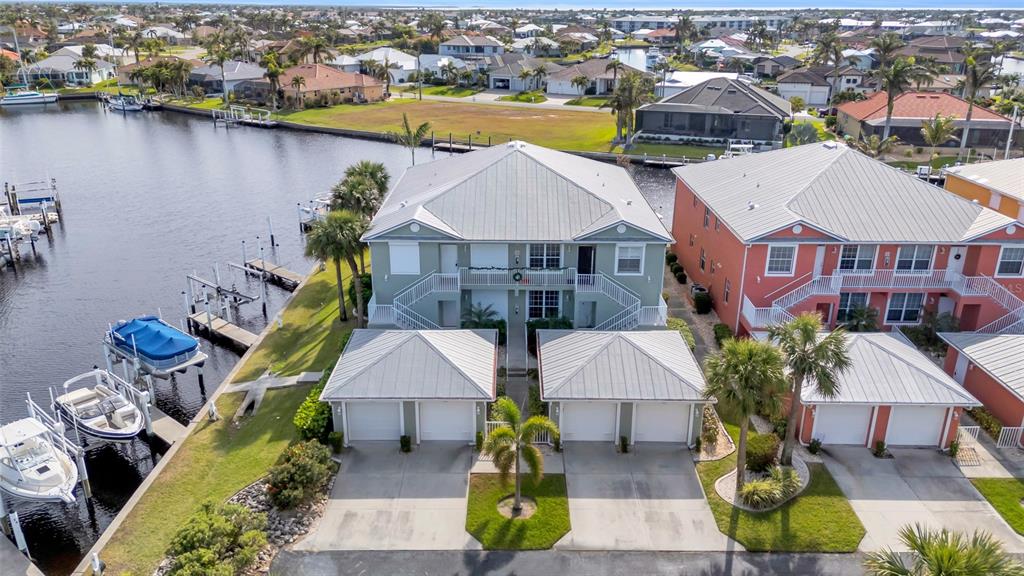 an aerial view of house with yard swimming pool and ocean view