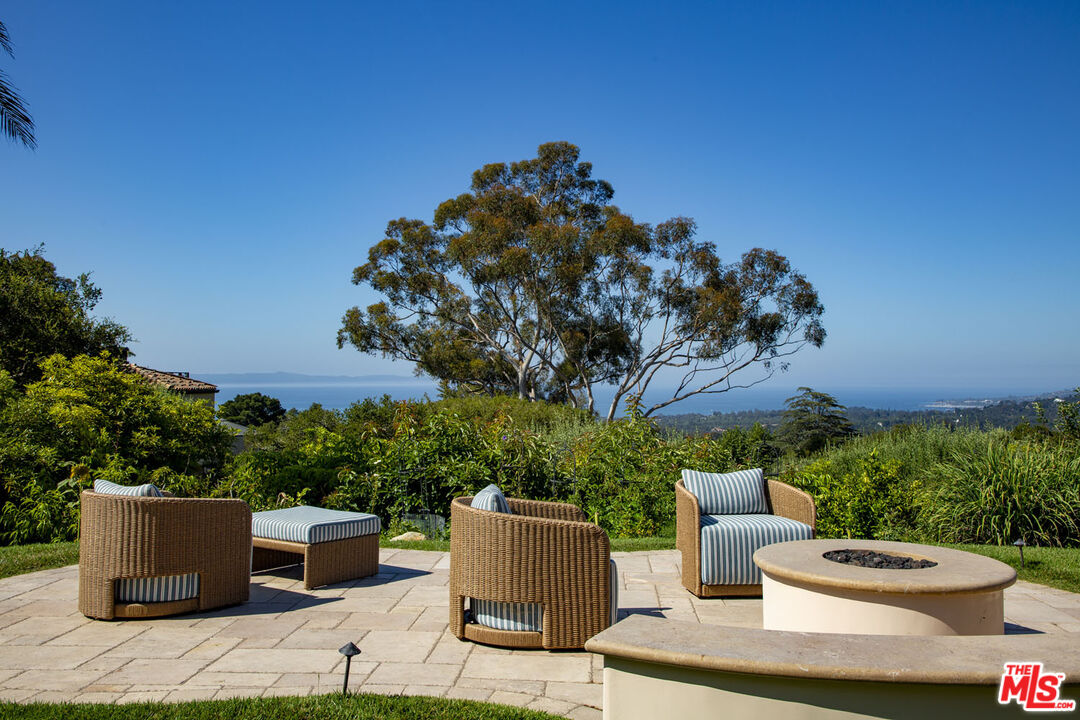 a backyard of a house with wooden floor barbeque oven and outdoor seating