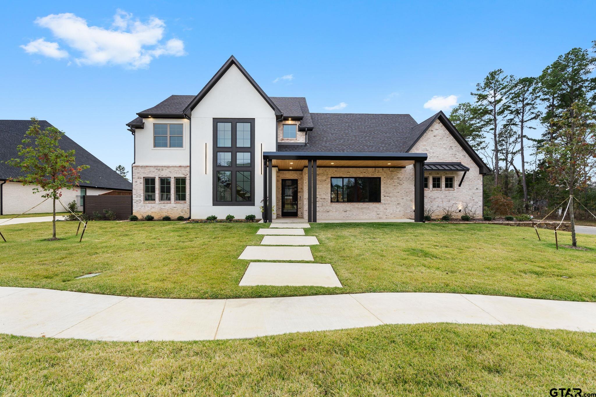 a front view of a house with a yard