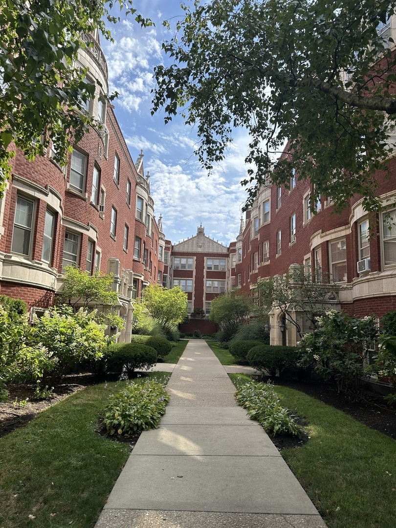 a view of a building next to a yard