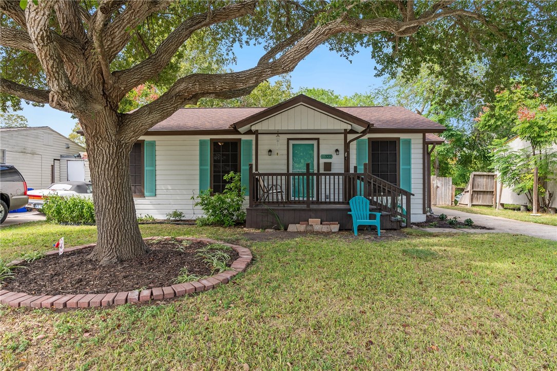 a view of a house with a yard porch and sitting area