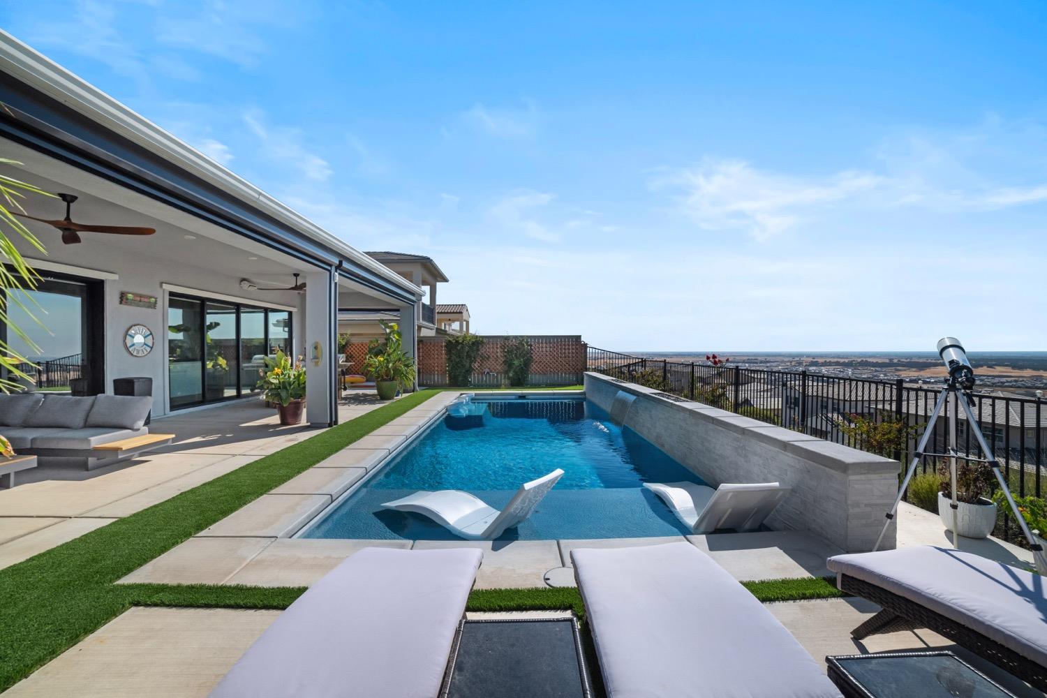 a view of swimming pool with seating area