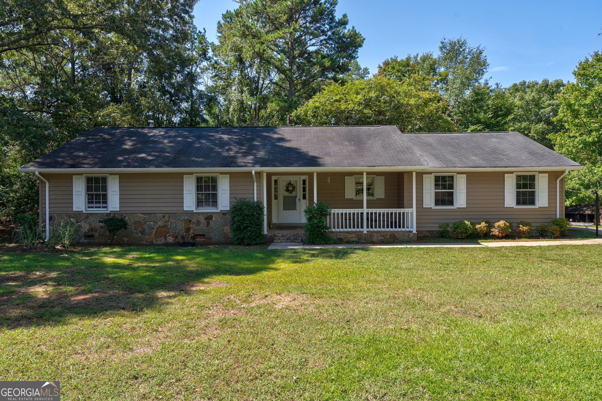 a front view of a house with a garden