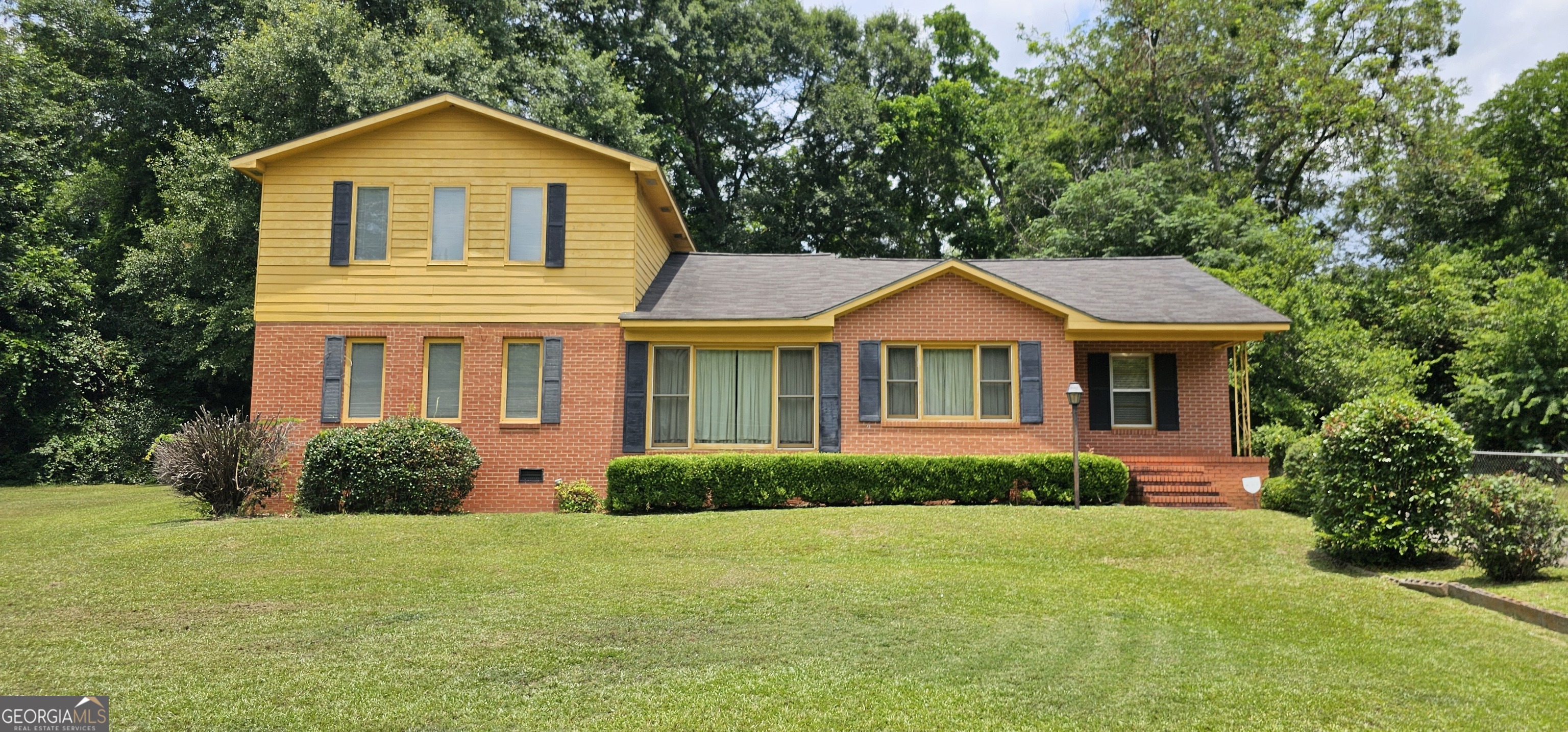 a front view of a house with garden