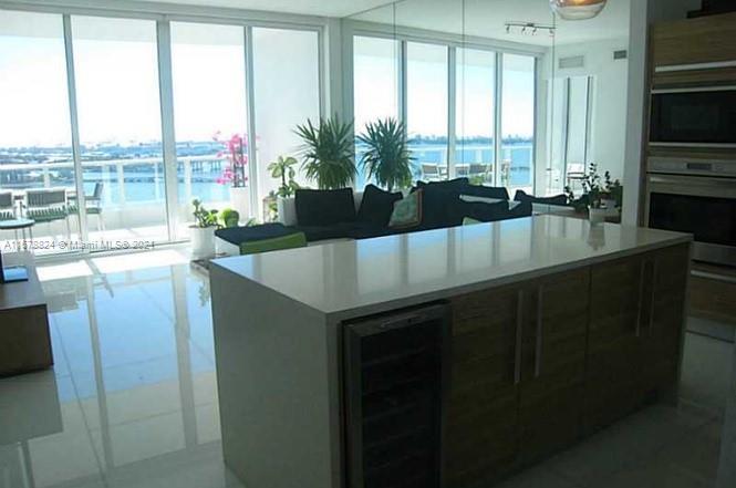 a living room with large window and a table