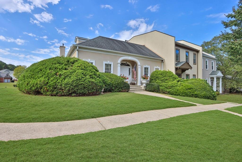 a front view of a house with a garden