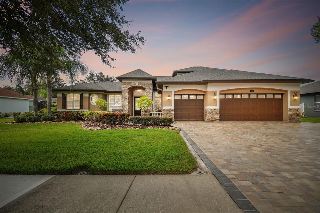 a front view of a house with a yard and garage