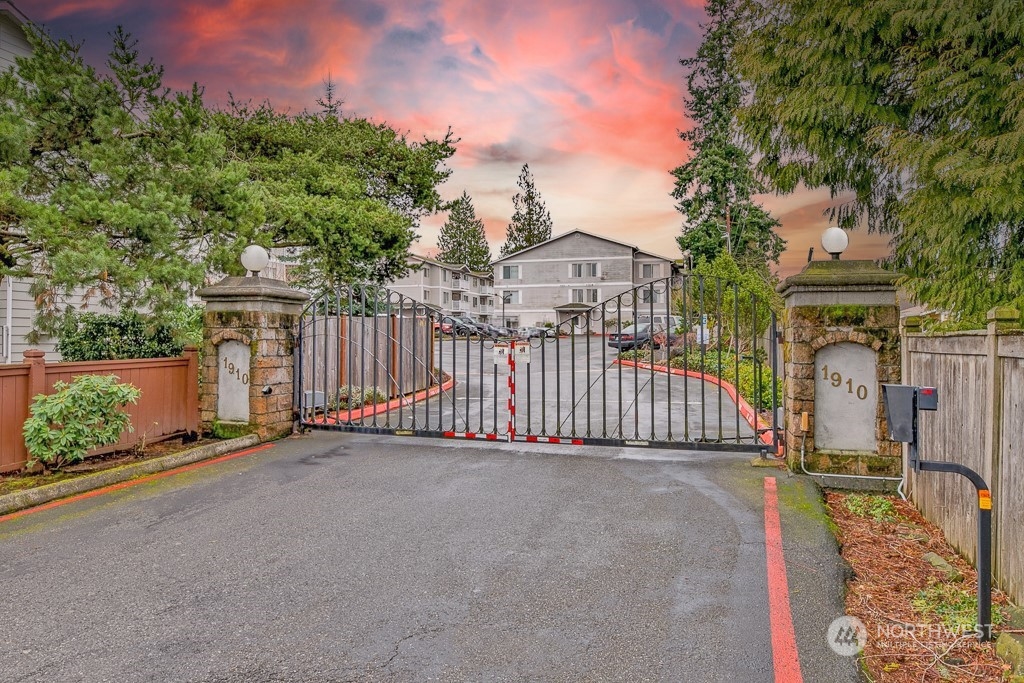 a view of a house with a wooden fence