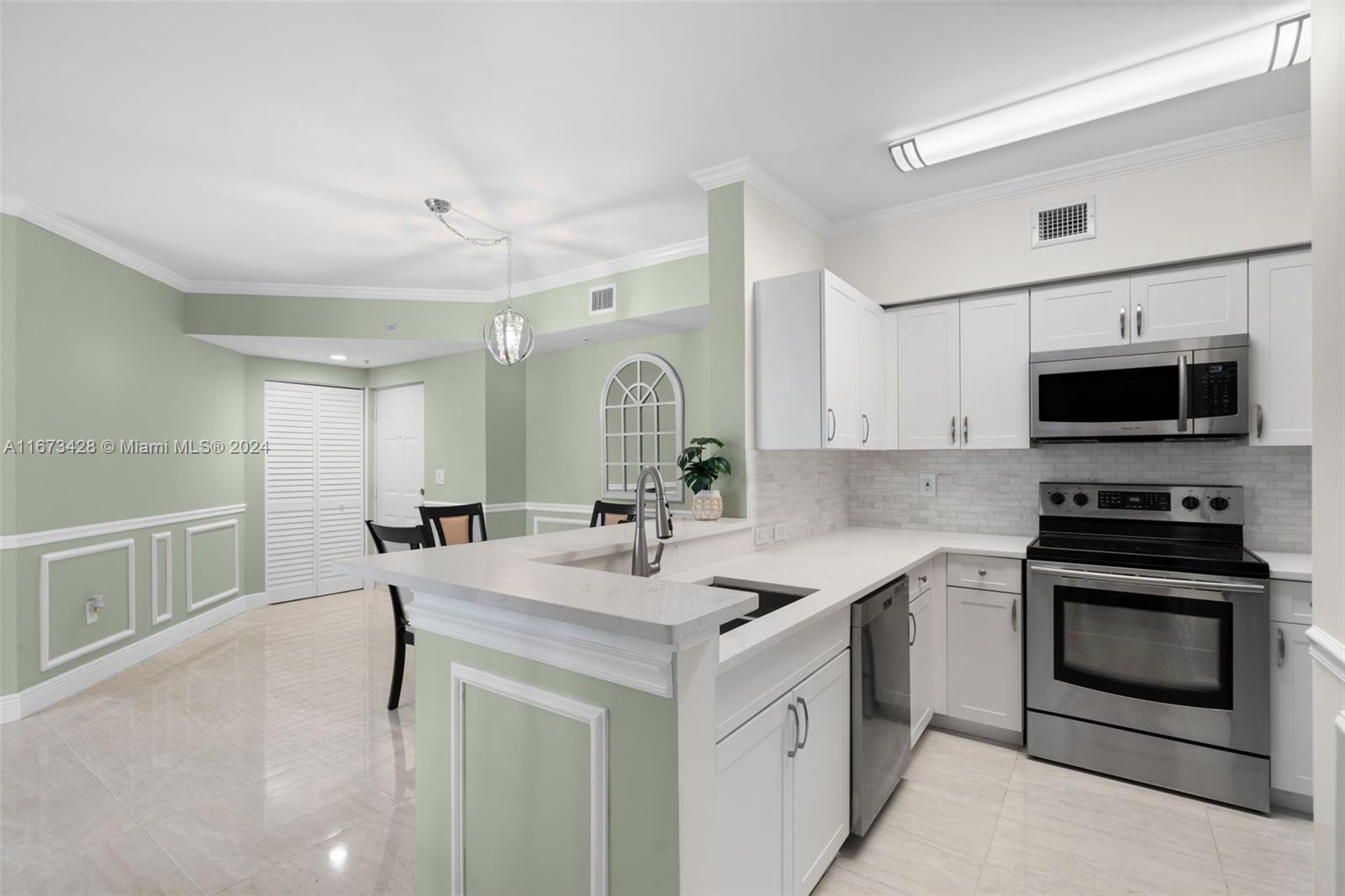 a kitchen with a sink stove and microwave