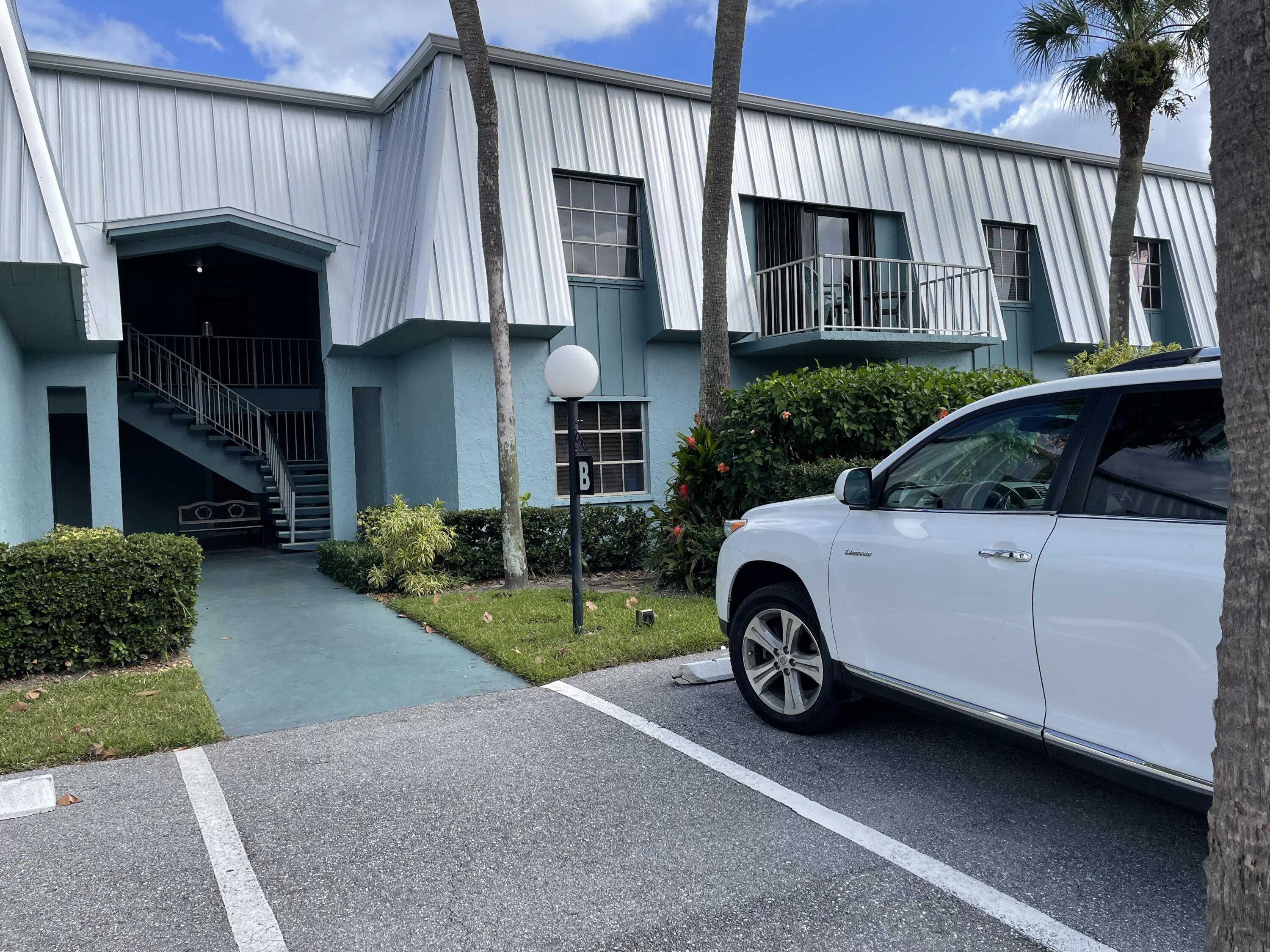 a view of a car in front view of a house