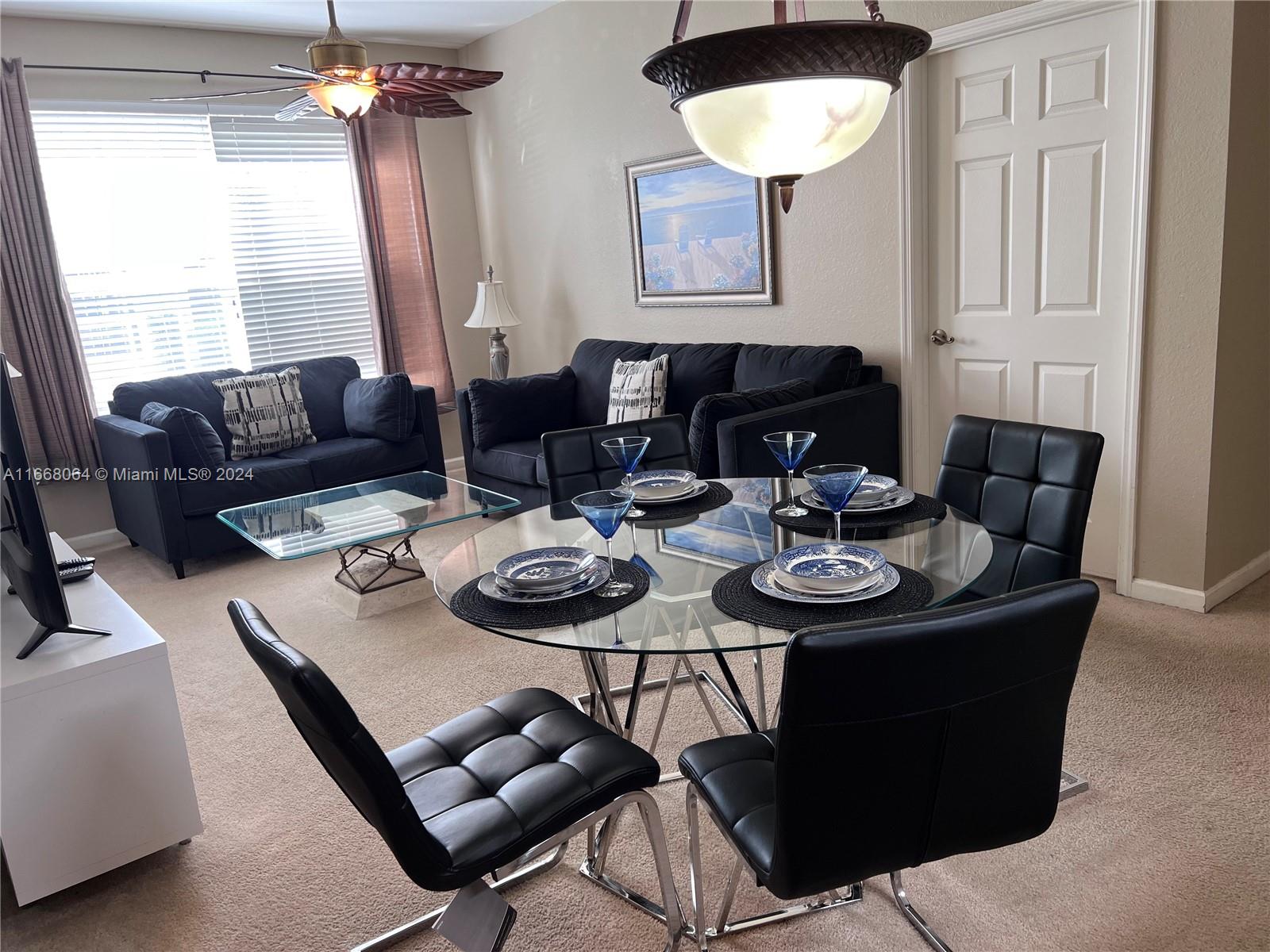 a view of a dining room with furniture and window