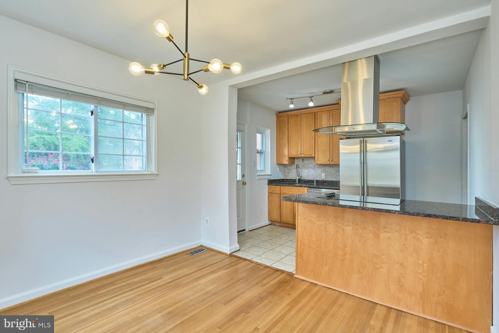 a view of a kitchen with wooden floor and a kitchen