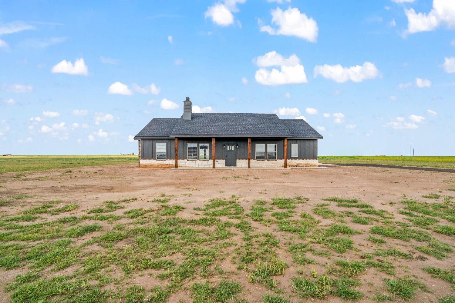 a front view of house with yard and lake view