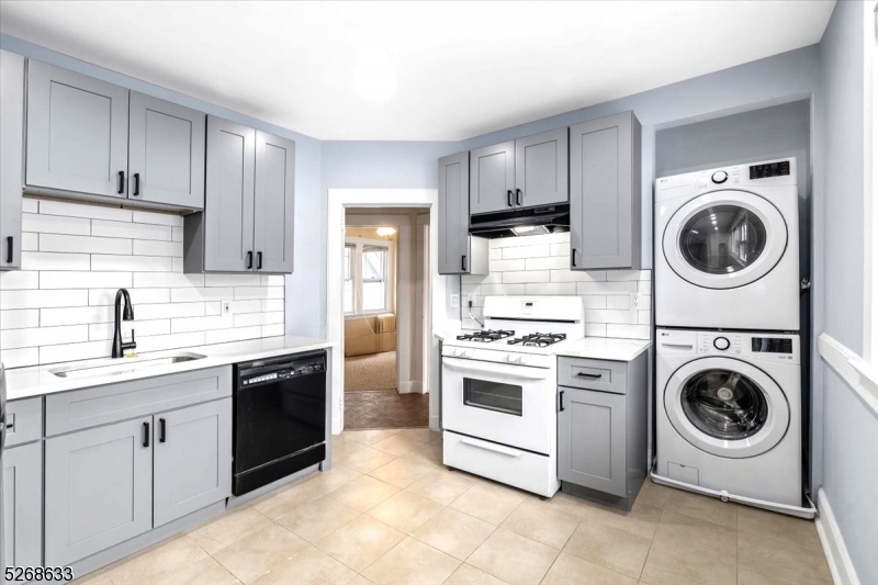 a kitchen with a stove top oven sink and cabinets