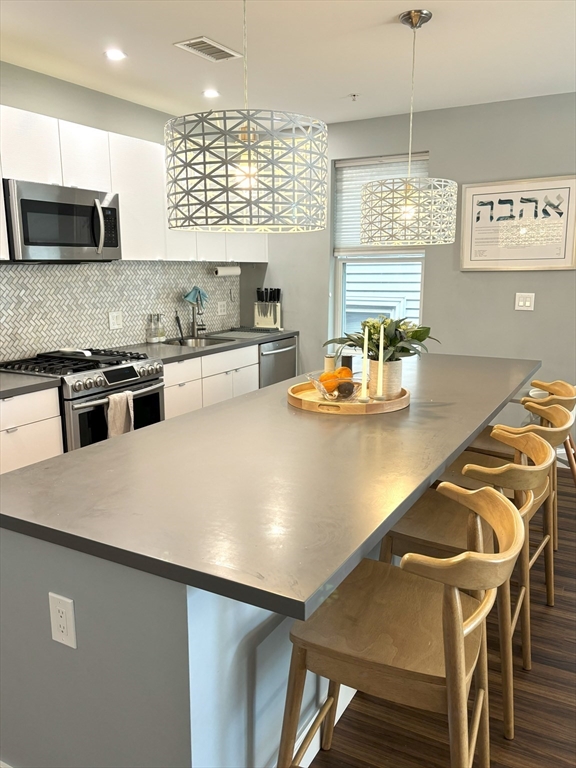 a kitchen with a table chairs stove and microwave