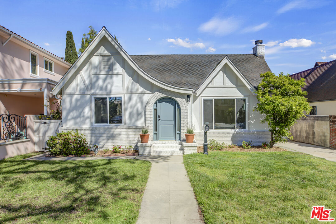 a front view of a house with garden