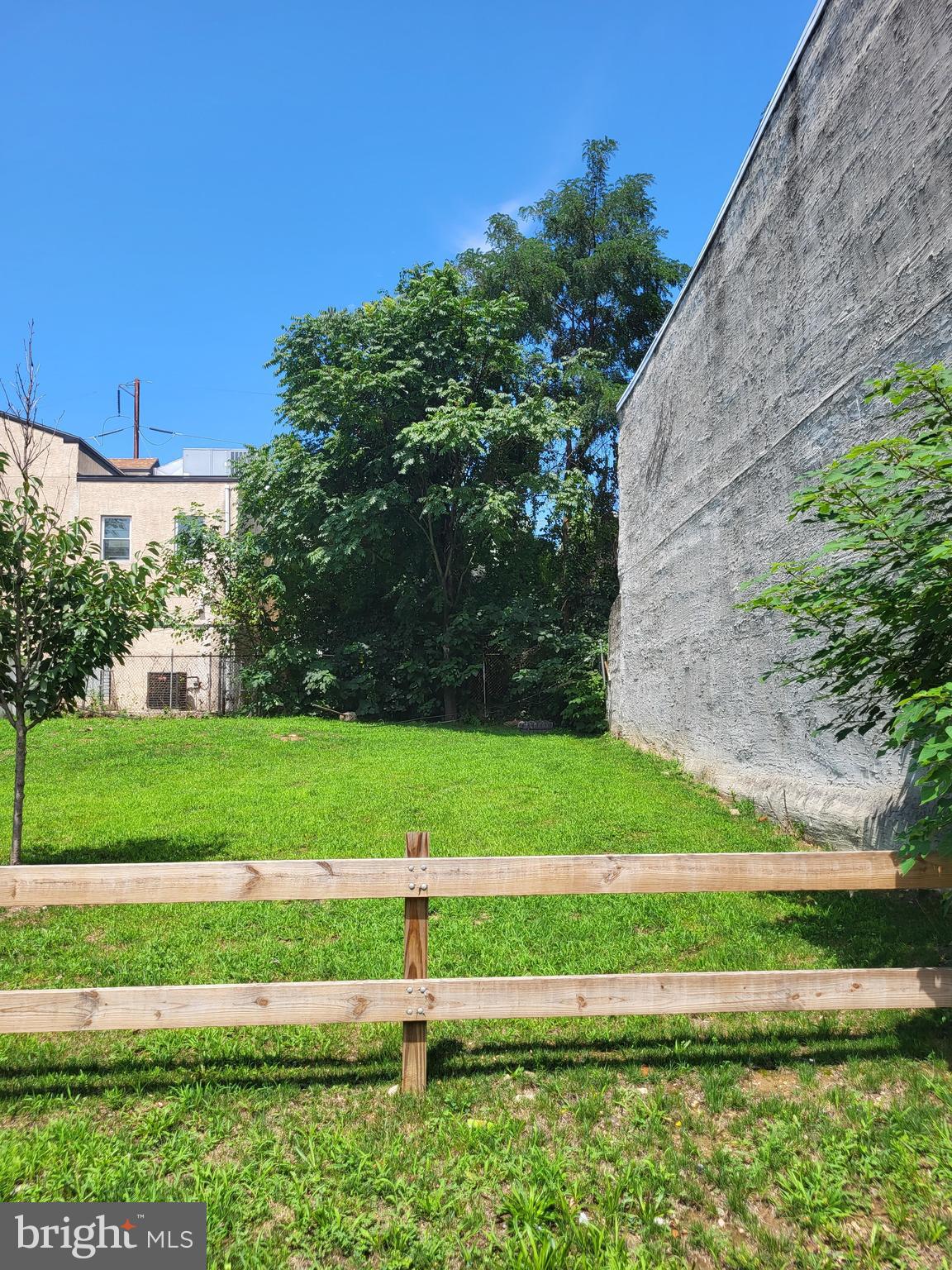 a view of green field with a small yard